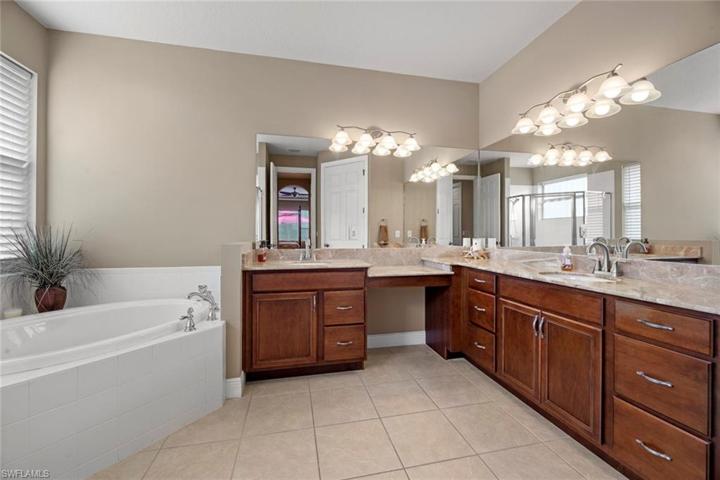 Master bath has dual sinks, make-up counter