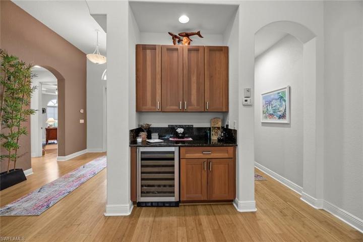 Bar area in great room w/beverage fridge, storage