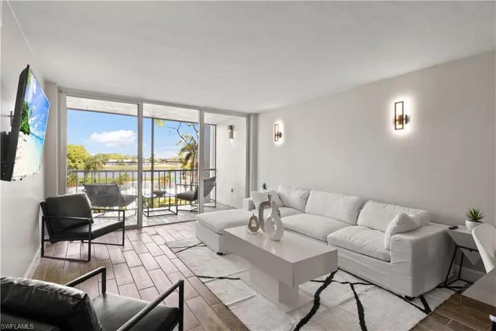 Bright living space with stylish new furnishings and peaceful lake vistas, creating a warm and welcoming atmosphere.