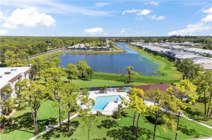 Breathtaking aerial view capturing the entire Bonita Pines community nestled alongside the expansive long lake, showcasing serene natural beauty and well-maintained grounds.