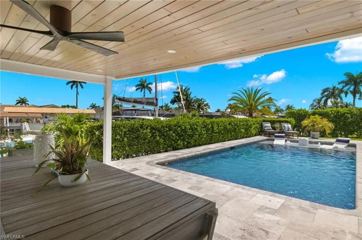 View of pool with a patio, ceiling fan, and a fenced in pool