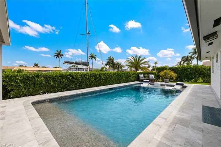 View of pool with a fenced in pool and a patio area
