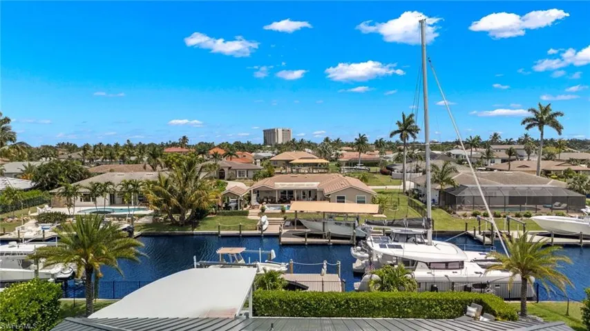 Birds eye view of property featuring a water view and a residential view