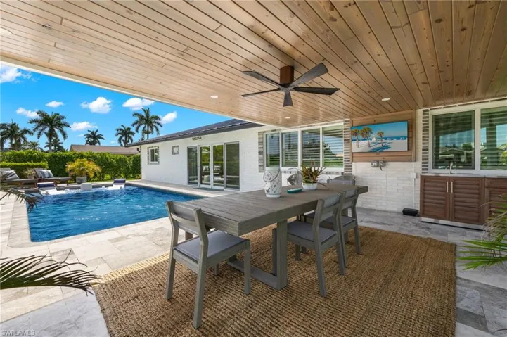 View of swimming pool featuring a fenced in pool, outdoor dining space, ceiling fan, and a patio area