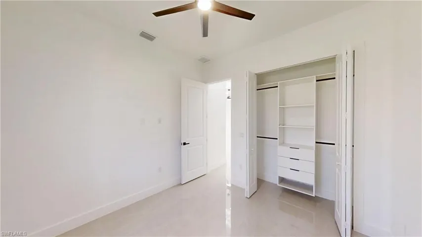 Unfurnished bedroom with a closet and ceiling fan