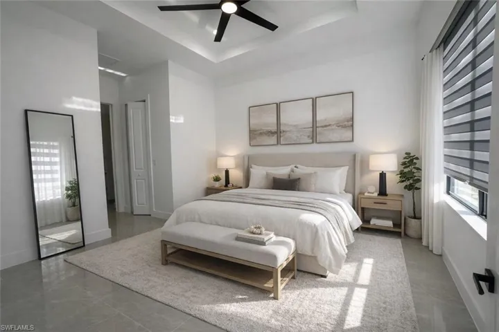 Bedroom featuring ceiling fan and a raised ceiling
