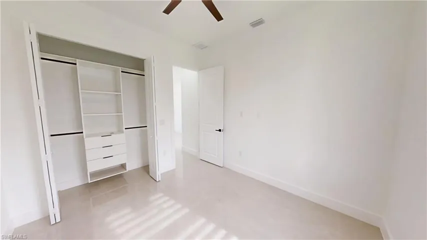 Unfurnished bedroom with a closet and ceiling fan