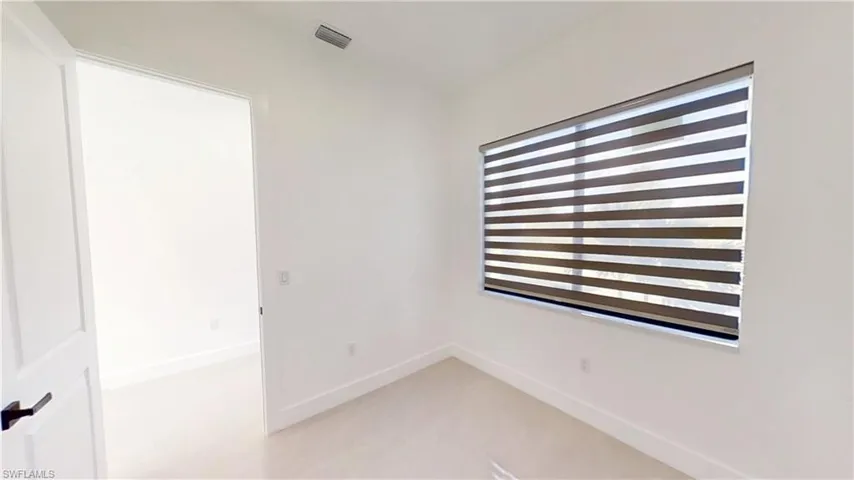 Spare room featuring baseboards