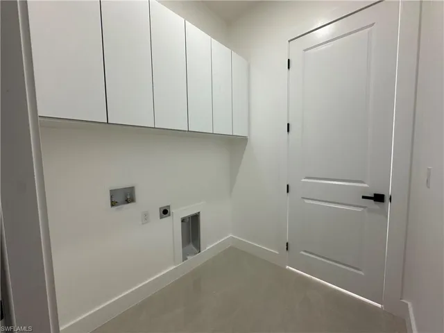 Laundry room with hookup for a washing machine, hookup for an electric dryer, and cabinet space