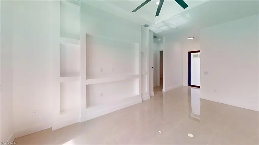 Unfurnished room with a ceiling fan and light tile patterned floors