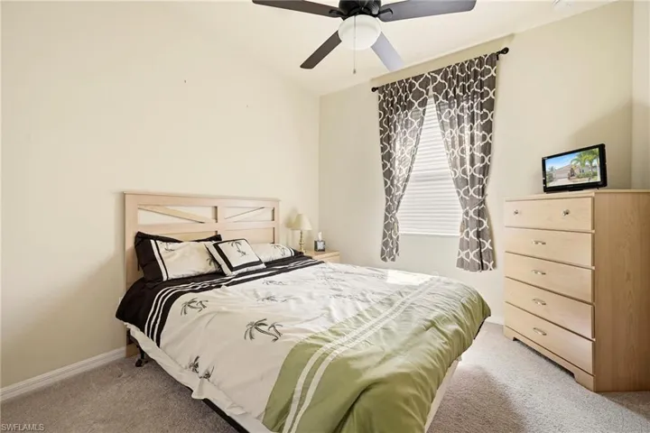 Bedroom featuring light colored carpet and a ceiling fan