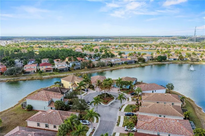 Aerial perspective of suburban area featuring a large body of water