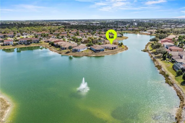 Aerial view of residential area featuring a nearby body of water