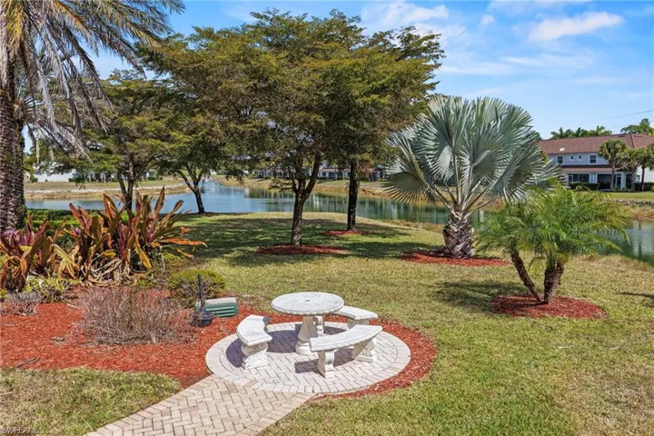 View of grassy yard featuring a water view and a patio