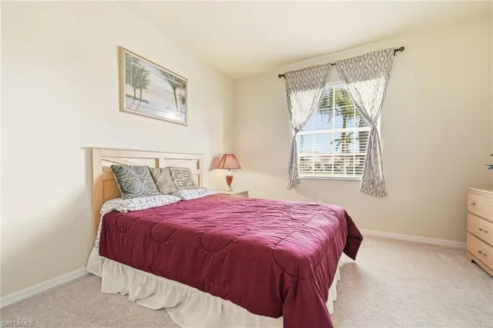 Bedroom with light carpet and baseboards