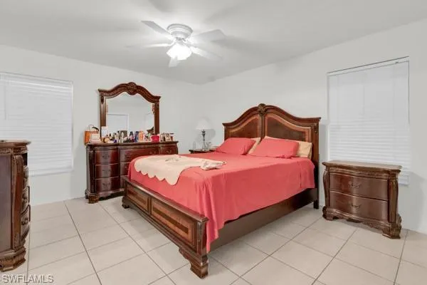 Bedroom with a ceiling fan and light tile patterned floors