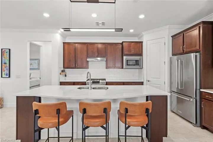 Large island w/extra storage, Quartz countertops, tile back splash
