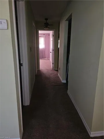 Hall with dark colored carpet