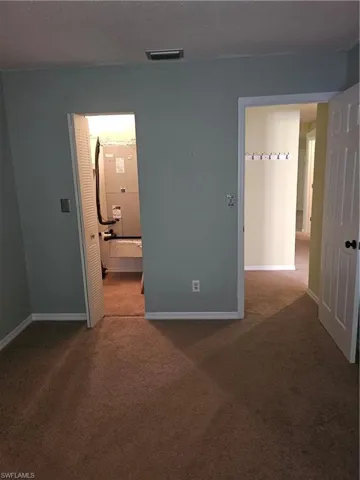 Carpeted spare room with a textured ceiling