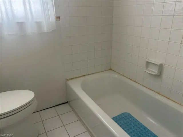 Full bathroom with toilet, tub, and a new vanity