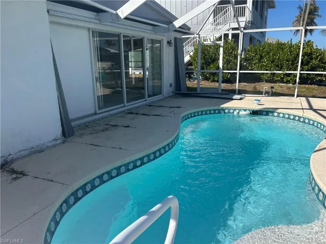 Outdoor pool featuring a lanai and a patio area