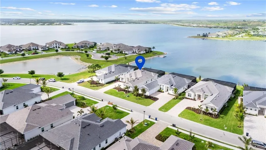 Birds eye view of property with a water view