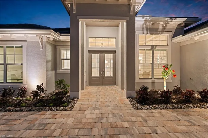 Exterior entry at dusk with french doors