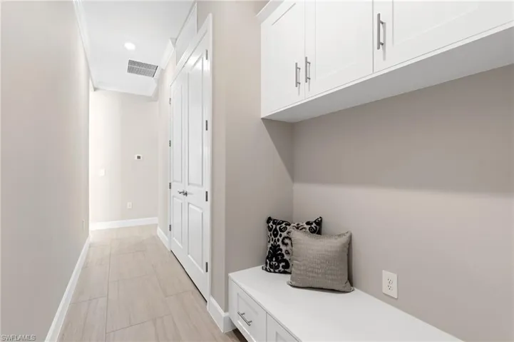Mudroom featuring crown molding