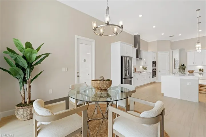 Dining room featuring crown molding and a chandelier