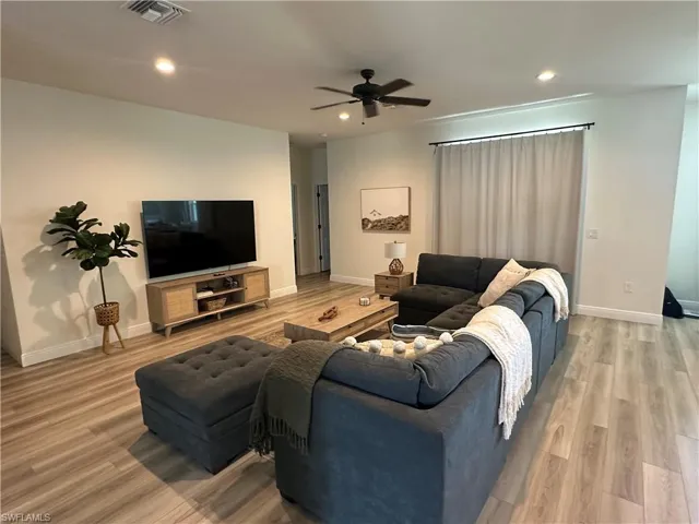 Living area featuring recessed lighting, light wood-type flooring, and a ceiling fan