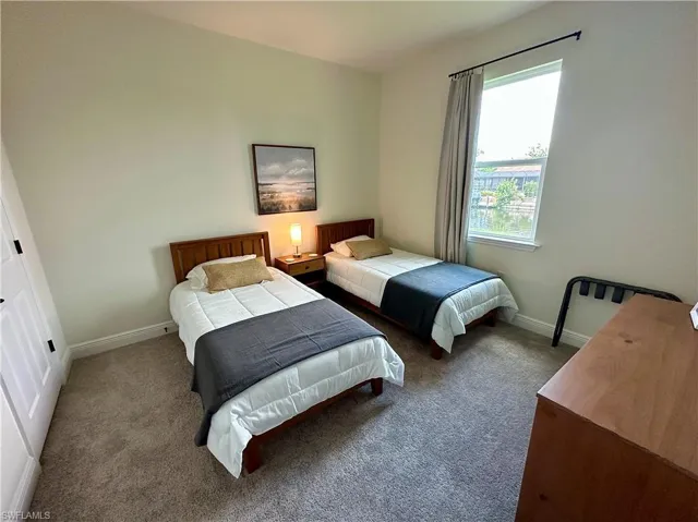 Bedroom with carpet flooring and baseboards