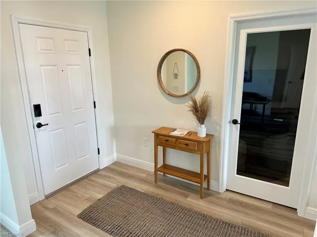 Entrance foyer featuring baseboards and light wood-style floors