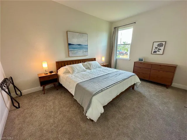 Carpeted bedroom with baseboards