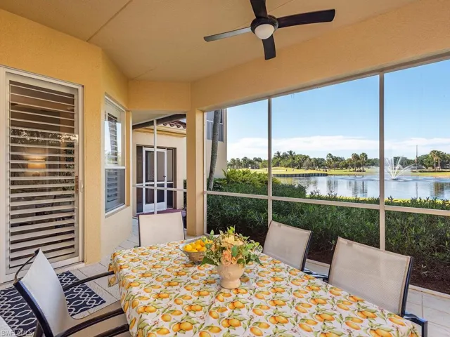 Sunroom / solarium featuring a water view and tile patterned flooring