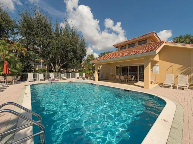 Community pool with a patio