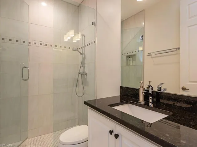 Bathroom with a shower stall and vanity