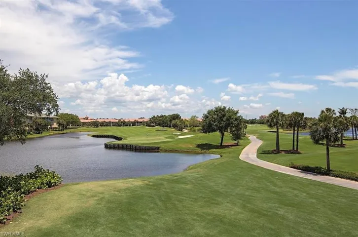 View of home's community featuring a water view, a yard, and golf course view