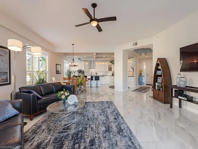 Living room featuring ceiling fan and light marble finish floors