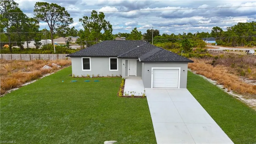 Single story home with stucco siding, concrete driveway, an attached garage, and roof with shingles