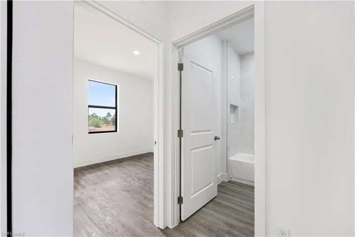 Hallway featuring light wood finished floors and recessed lighting