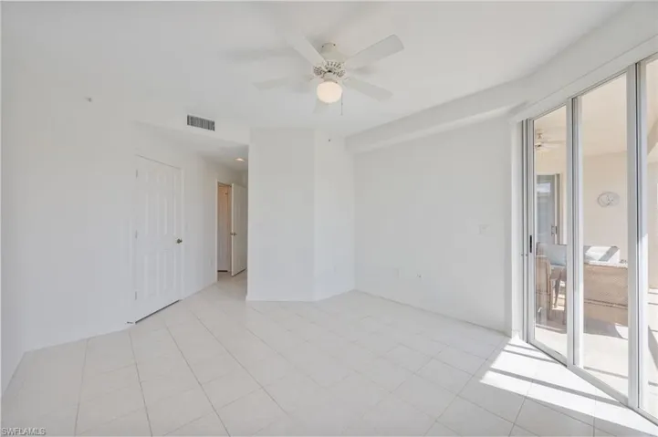 Primary bedroom with sliding door access to the lanai