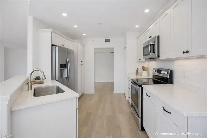 AI Renovated/Virtually Staged.  Kitchen with updated cabinetry and stainless steel appliances.