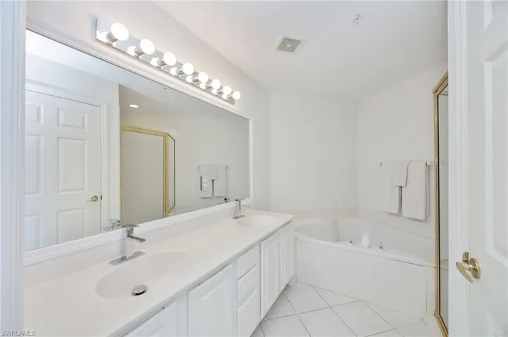 Has two sinks, a walk in shower and a large soaking tub