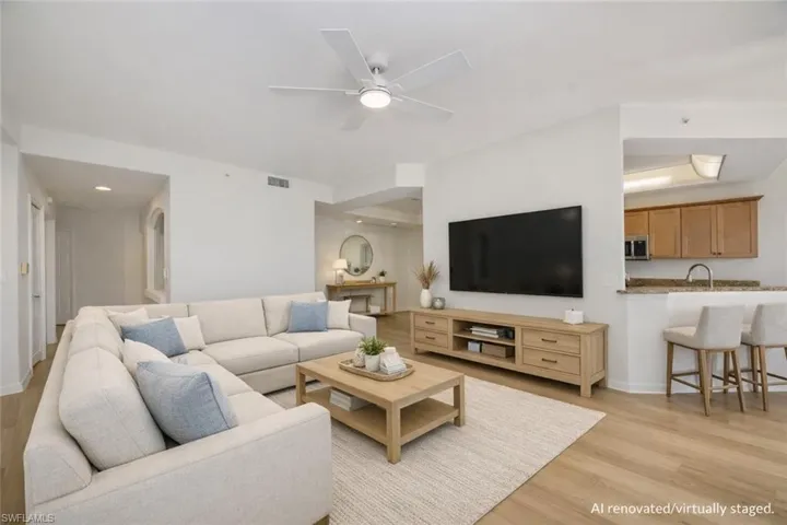 AI Renovated/Virtually Staged. Family room facing kitchen and dining room