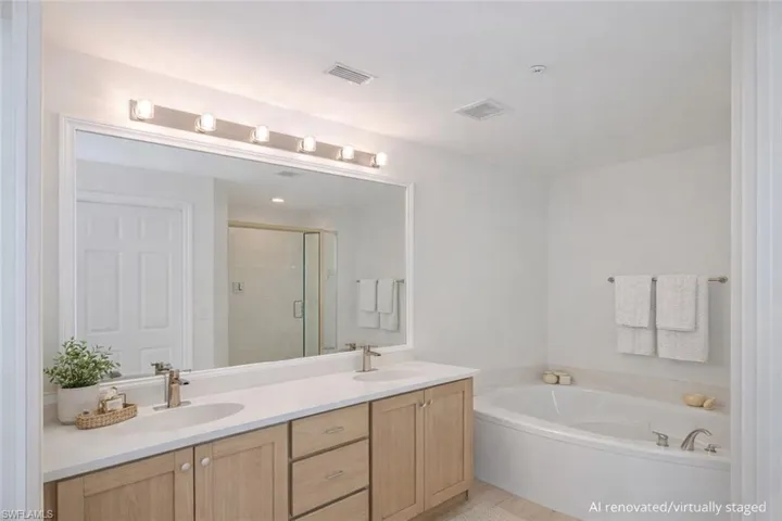 AI Renovated/Virtually Staged.  Primary bathroom.