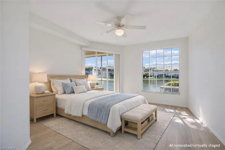 AI Renovated/Virtually Staged.  Primary bedroom with sliding door access to the lanai.