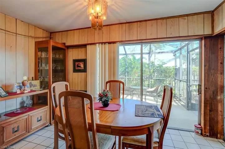Dining room featuring wood walls and light tile patterned floors