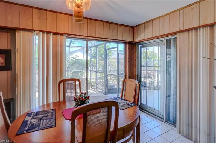 Dining space with wooden walls and light tile patterned floors
