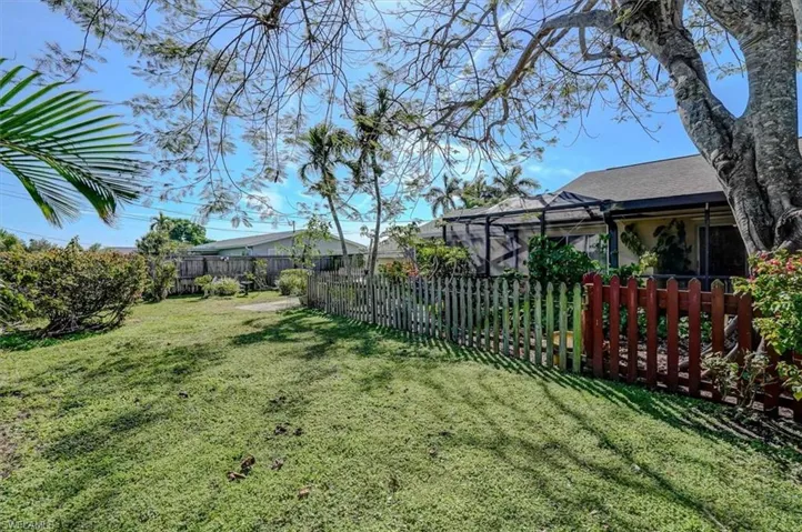 View of yard featuring a lanai and a fenced backyard