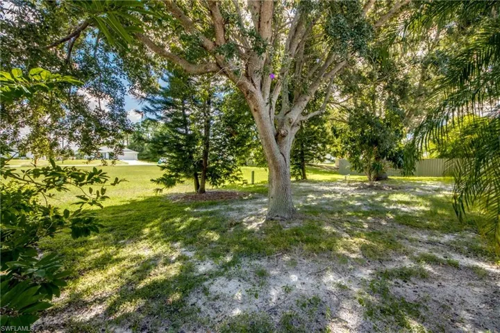 Grounds featuring mature trees, native landscaping, and expansive green space